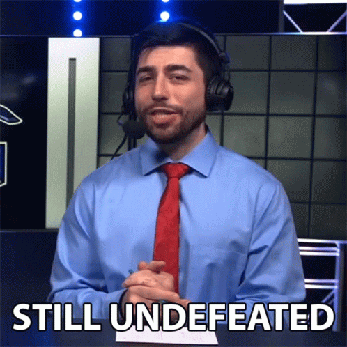 Man In Blue Shirt And Red Tie Saying Still Undefeated GIF