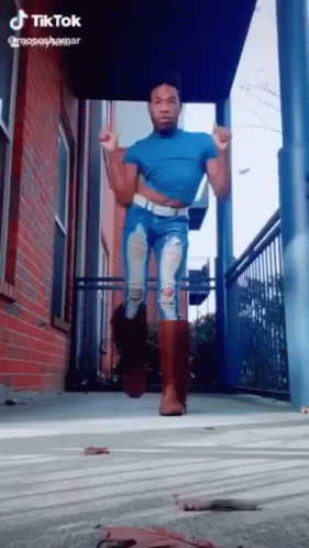 Man in Blue Shirt and Ripped Jeans Dancing