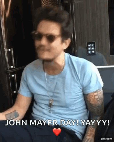Man in Blue Shirt and Sunglasses Saying John Mayer Day