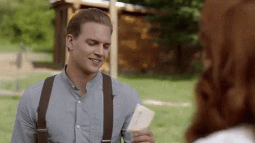 Man In Blue Shirt And Suspenders Holding Paper GIF