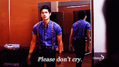 Man in Blue Shirt and Suspenders Saying Please Don't Cry