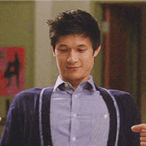 Man in Blue Shirt and Suspenders Smiling