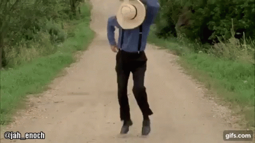 Man in Blue Shirt and Suspenders Walking