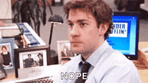 Man in Blue Shirt and Tie at Computer Saying Nope