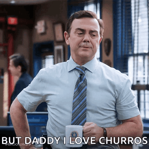 Man in Blue Shirt and Tie Holding Mug Saying Daddy I Love Churros