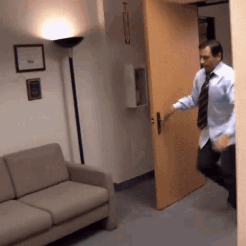 Man in Blue Shirt and Tie Opening Door