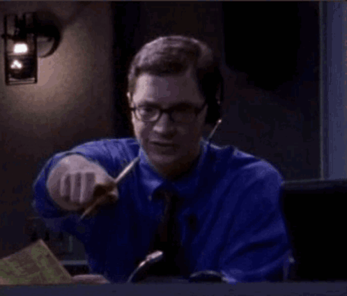 Man In Blue Shirt And Tie Pointing With Pen GIF