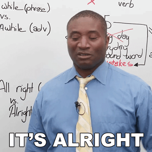 Man in Blue Shirt and Tie Standing in Front of Whiteboard