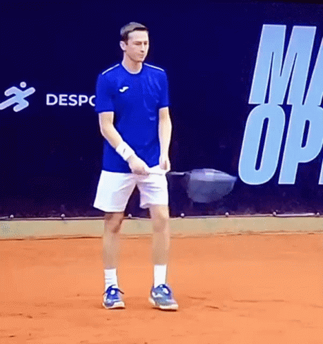Man in Blue Shirt and White Shorts on Court