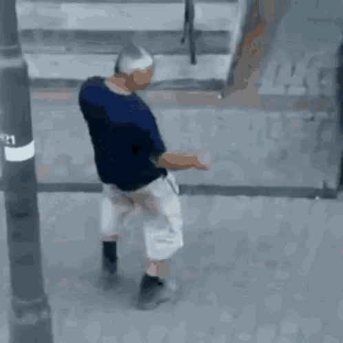 Man in Blue Shirt and White Shorts Walking
