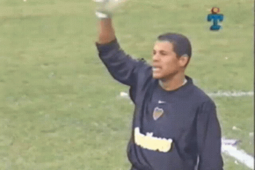 Man in Blue Shirt Arm Up Soccer Field