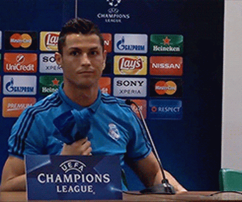Man in Blue Shirt at Champions League Sign