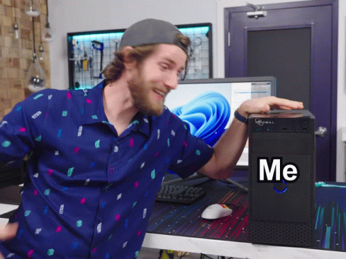 Man in Blue Shirt at Computer Saying Me