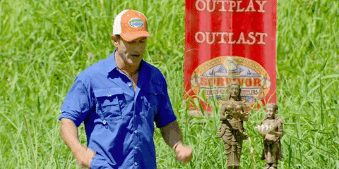 Man in Blue Shirt at Red Outplay Outlast Sign