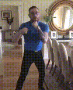 Man in Blue Shirt Boxing in Living Room