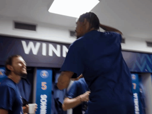 Man in Blue Shirt by Winn Sign