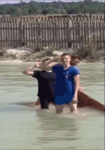 Man In Blue Shirt C Standing In Water GIF