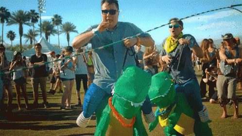Man In Blue Shirt Carrying Dinosaurs GIF
