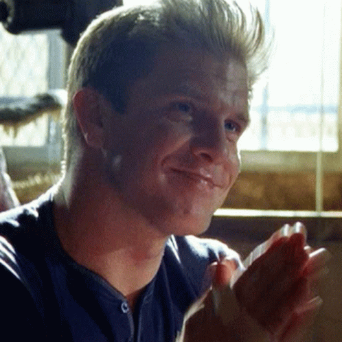 Man in Blue Shirt Clapping and Smiling