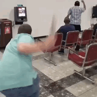 Man in Blue Shirt Dancing in Waiting Room