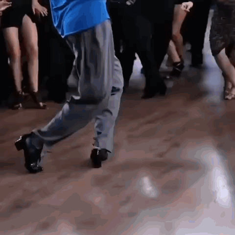 Man In Blue Shirt Dancing On Wooden Floor GIF