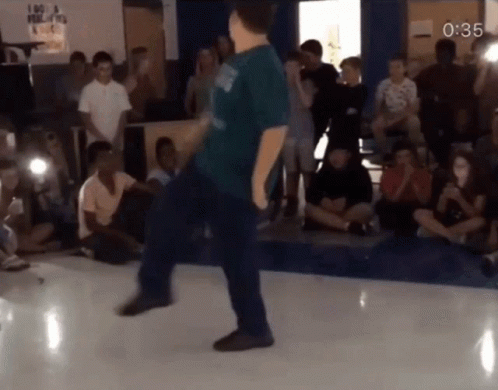 Man In Blue Shirt Dancing With Sign I Am A Filipino GIF