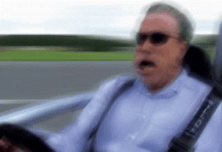 Man in Blue Shirt Driving Car