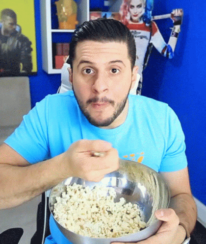 Man In Blue Shirt Eating Popcorn GIF