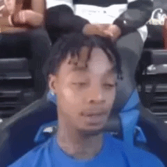 Man in Blue Shirt Eyes Closed Funny Face in Stadium