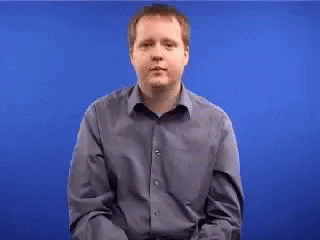 Man in Blue Shirt Gesturing