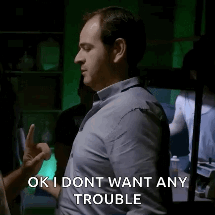 Man In Blue Shirt Giving Middle Finger Saying OK I Dont Want Any Trouble GIF