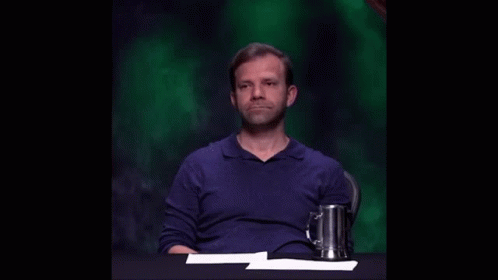 Man in Blue Shirt Hand Up Funny Face