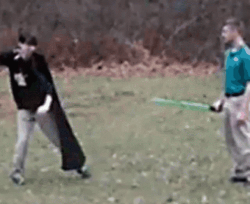 Man in Blue Shirt Holding Green Sword