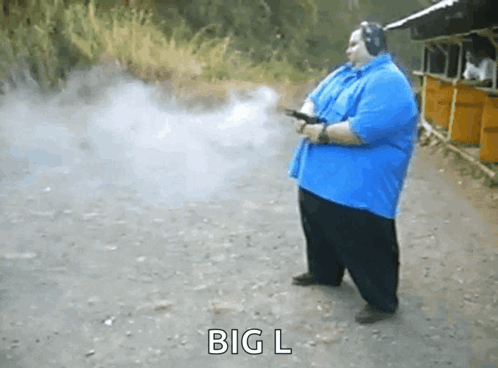 Man In Blue Shirt Holding Gun GIF