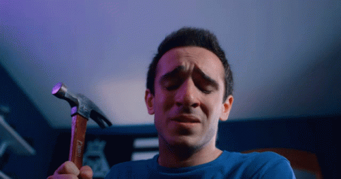 Man In Blue Shirt Holding Hammer GIF