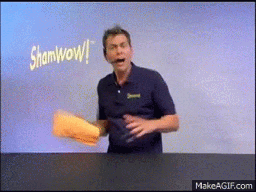 Man in Blue Shirt Holding Paper Saying Shamwow