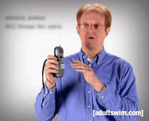 Man in Blue Shirt Holding Phone Adult Swim.com