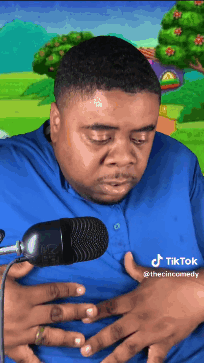 Man in Blue Shirt Holding Stomach