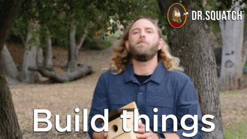 Man in Blue Shirt Holding Wood Build Things