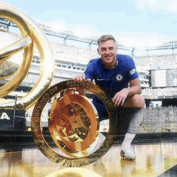 Man in Blue Shirt Holding World Cup Trophy
