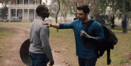 Man in Blue Shirt Hugging Another Man
