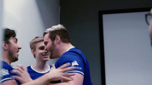 Man in Blue Shirt Hugging Another