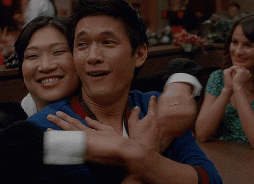 Man in Blue Shirt Hugging Woman in Green Dress