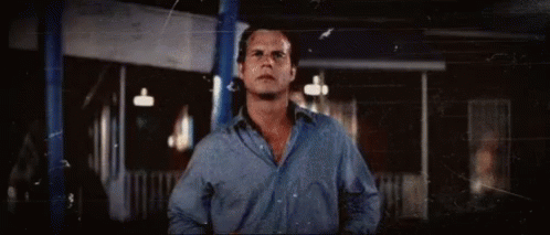 Man in Blue Shirt in Front of Building