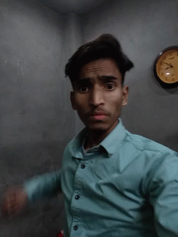 Man in Blue Shirt in Front of Casio Clock