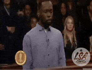 Man In Blue Shirt In Front Of Crowd With LSA Audience Logo GIF