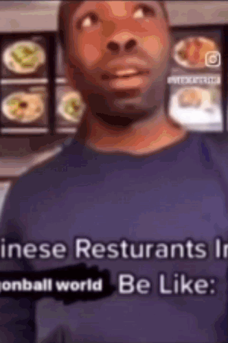 Man in Blue Shirt in Front of Food Display