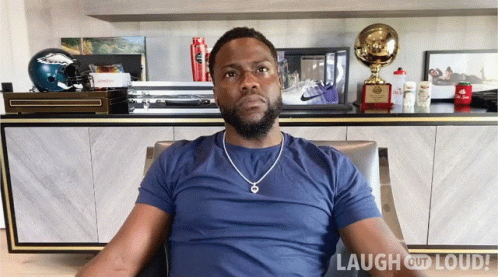 Man in Blue Shirt in Front of Laugh Out Loud Logo