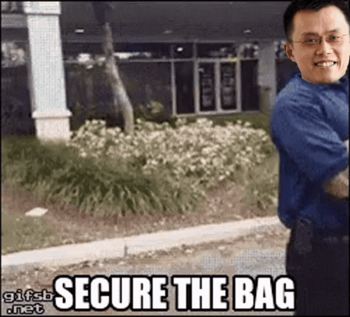 Man in Blue Shirt in Front of Secure the Bag Building