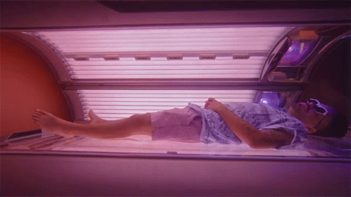 Man in Blue Shirt in Tanning Bed